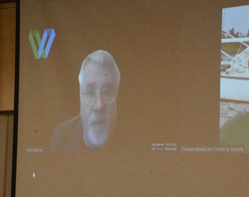 Green-chemistry pioneer John Warner presenting his keynote remotely on the projection screen