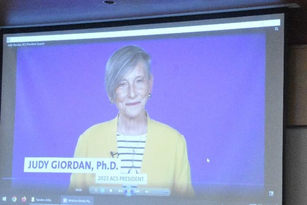 ACS President Dr. Judy Giordan delivering a video congratulatory address shown on screen