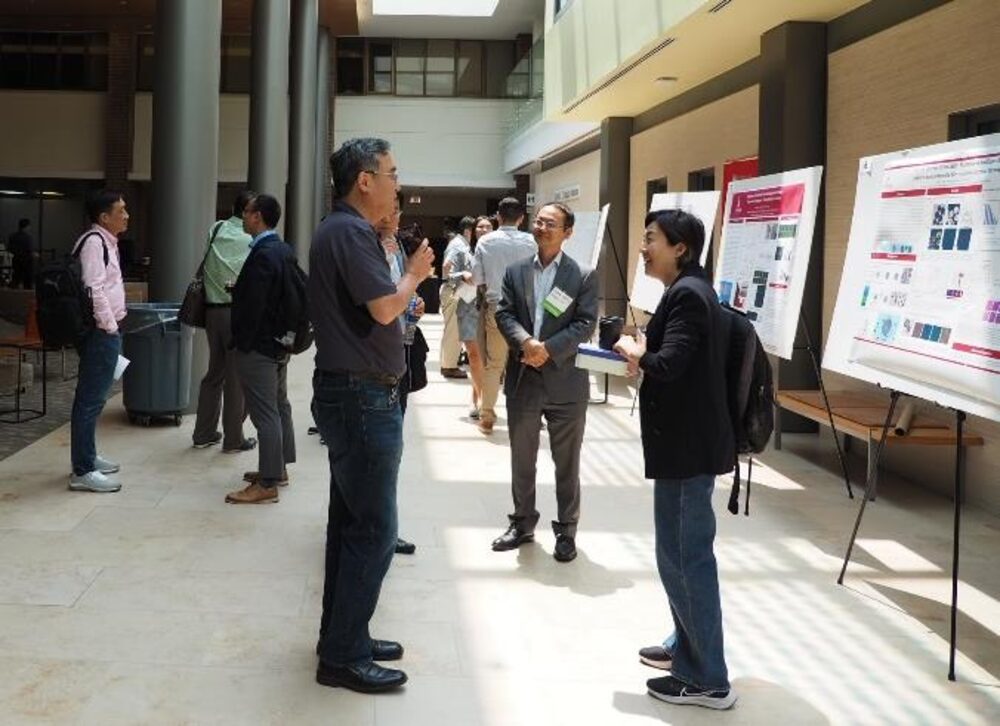 Attendees discussing posters during the symposium poster session