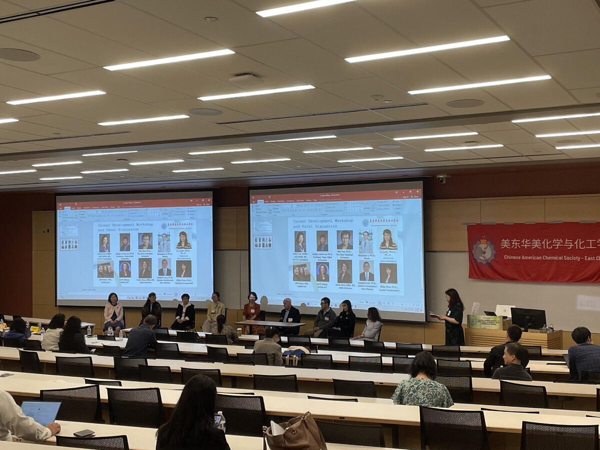 Career Development Panel underway in the Rutgers lecture hall, with panelists seated at the front and panel slides projected on screens