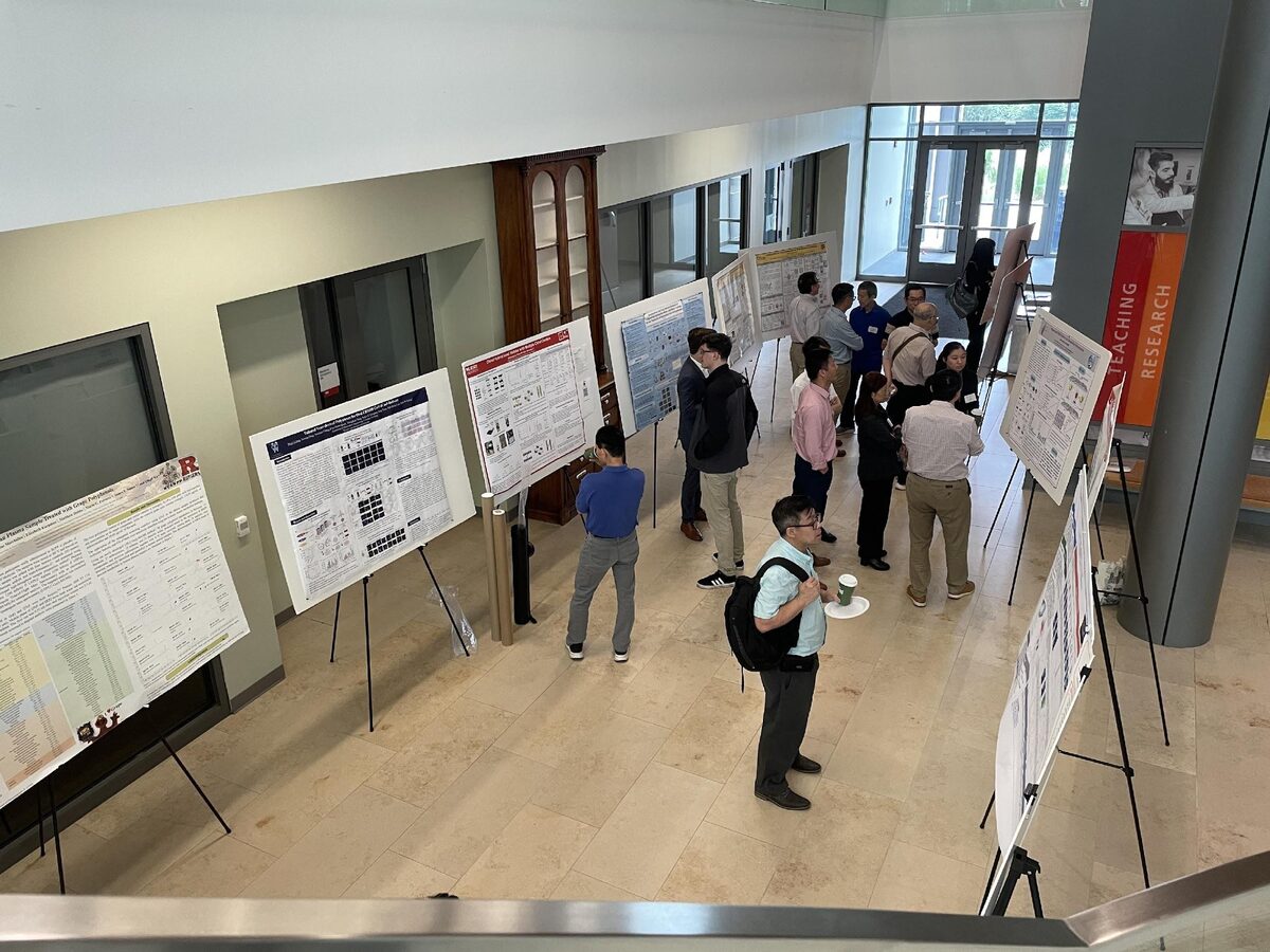 Attendees discussing posters at the symposium poster session