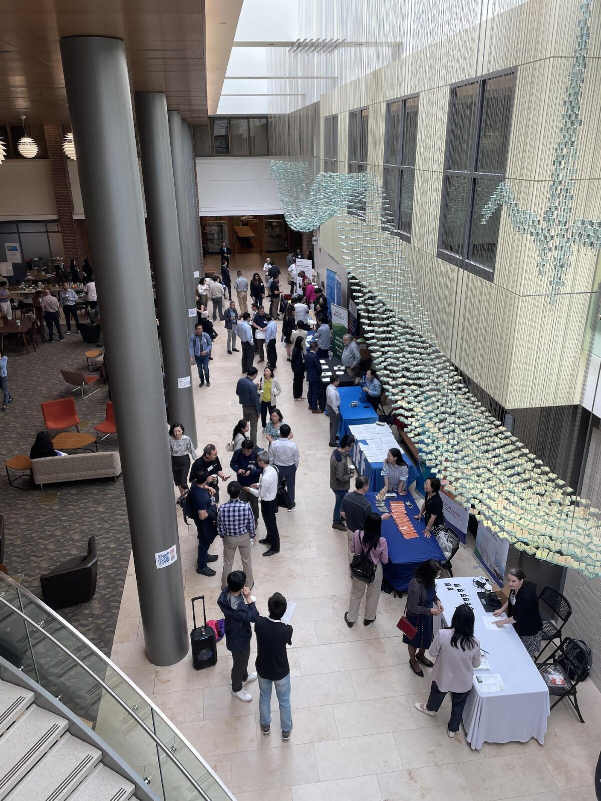 Vendor show in the Rutgers atrium, with sponsor tables lining the lobby and attendees networking