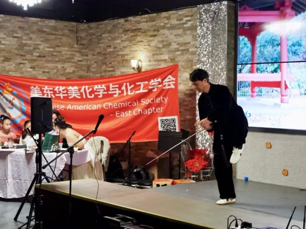 Calligrapher Liwei Fang inscribing a Spring Festival couplet on stage during the gala