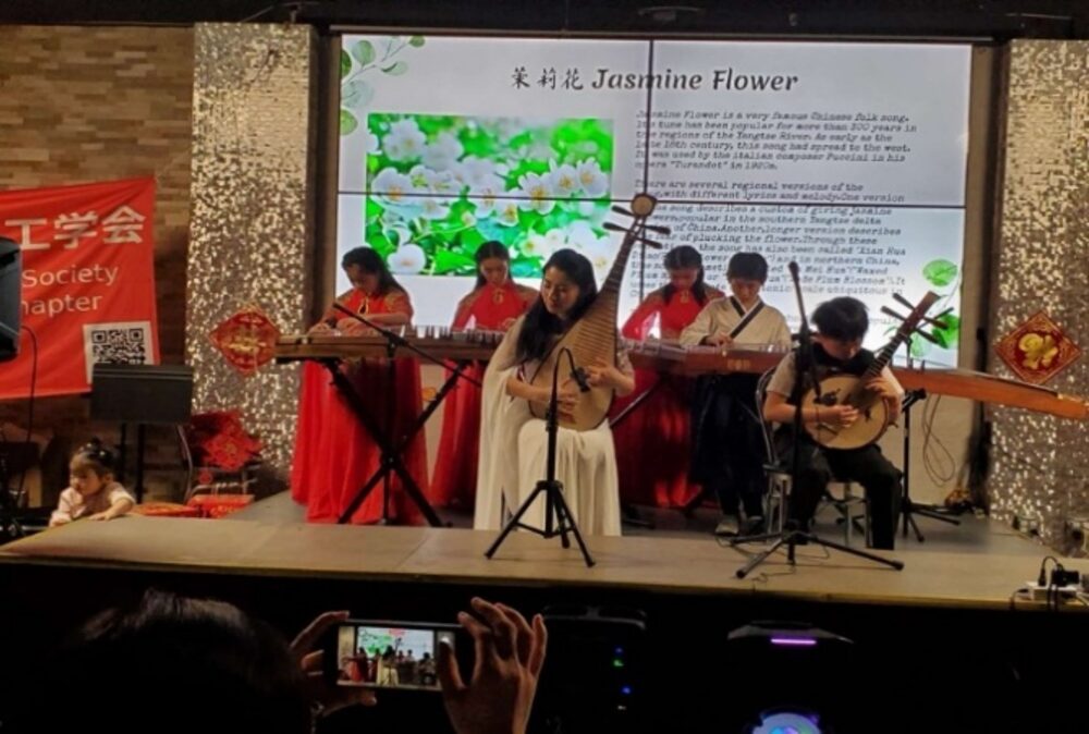 Pipa soloist Jin Yang and ensemble performing "Jasmine Flower" on stage at the gala