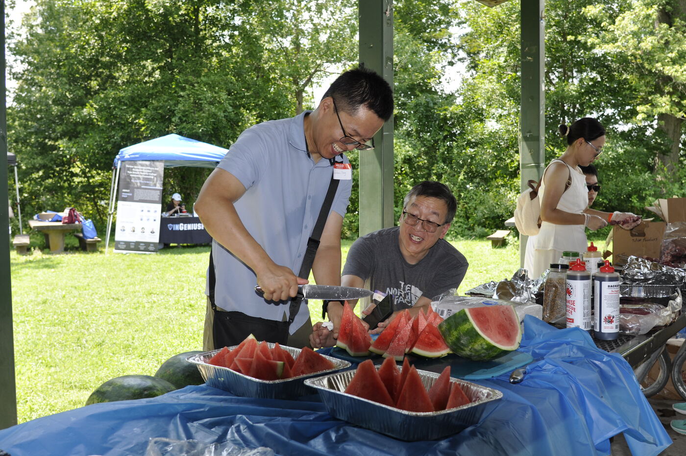A volunteer slicing watermelon for the crowd.