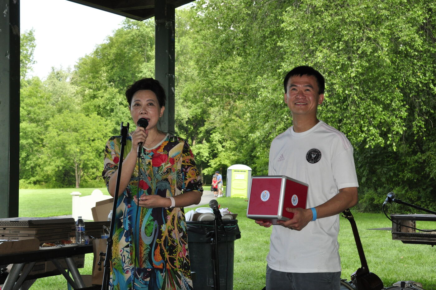 An organizer presenting an award at the microphone.