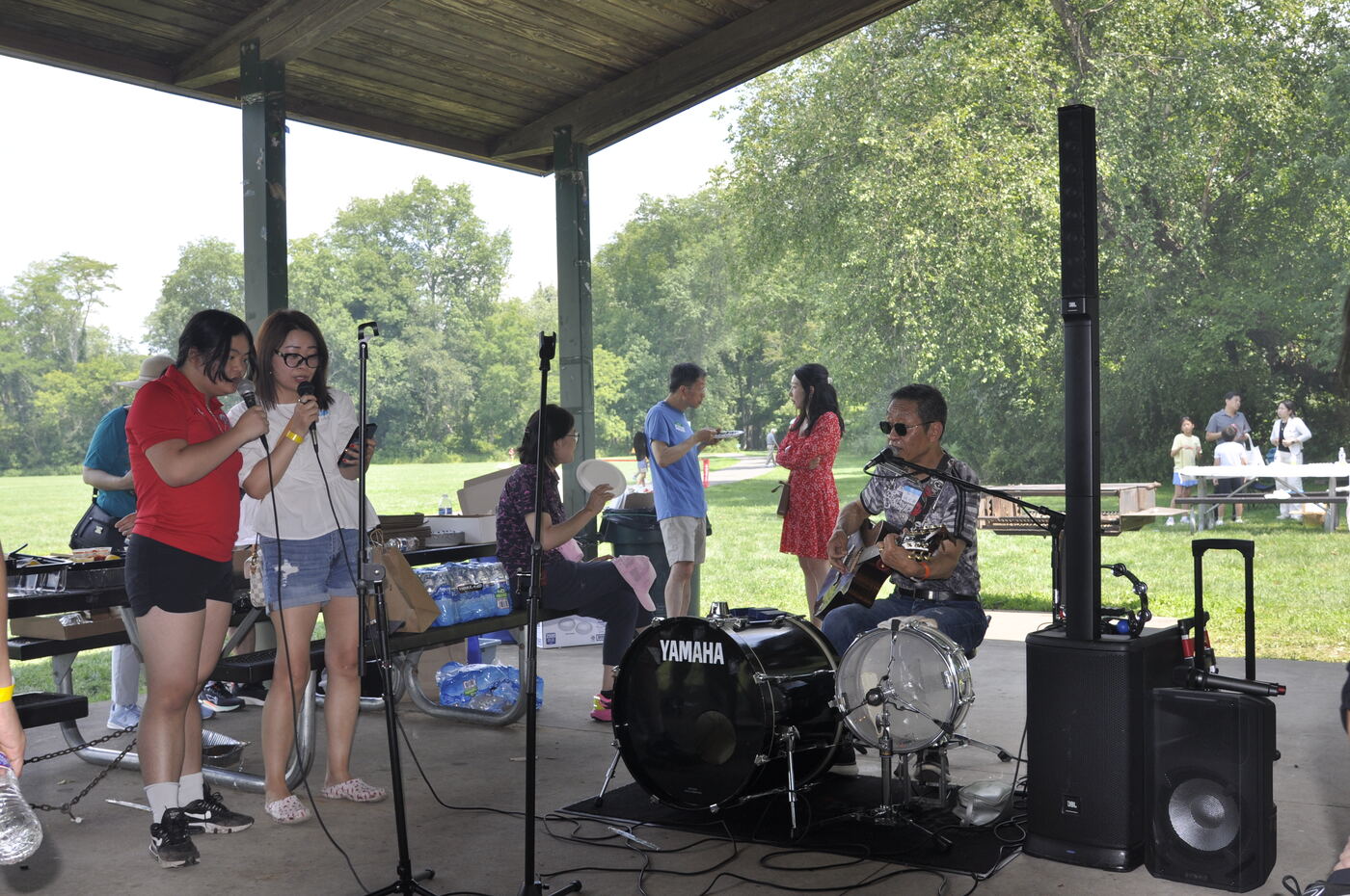 Two young performers singing a duet with the band behind them.
