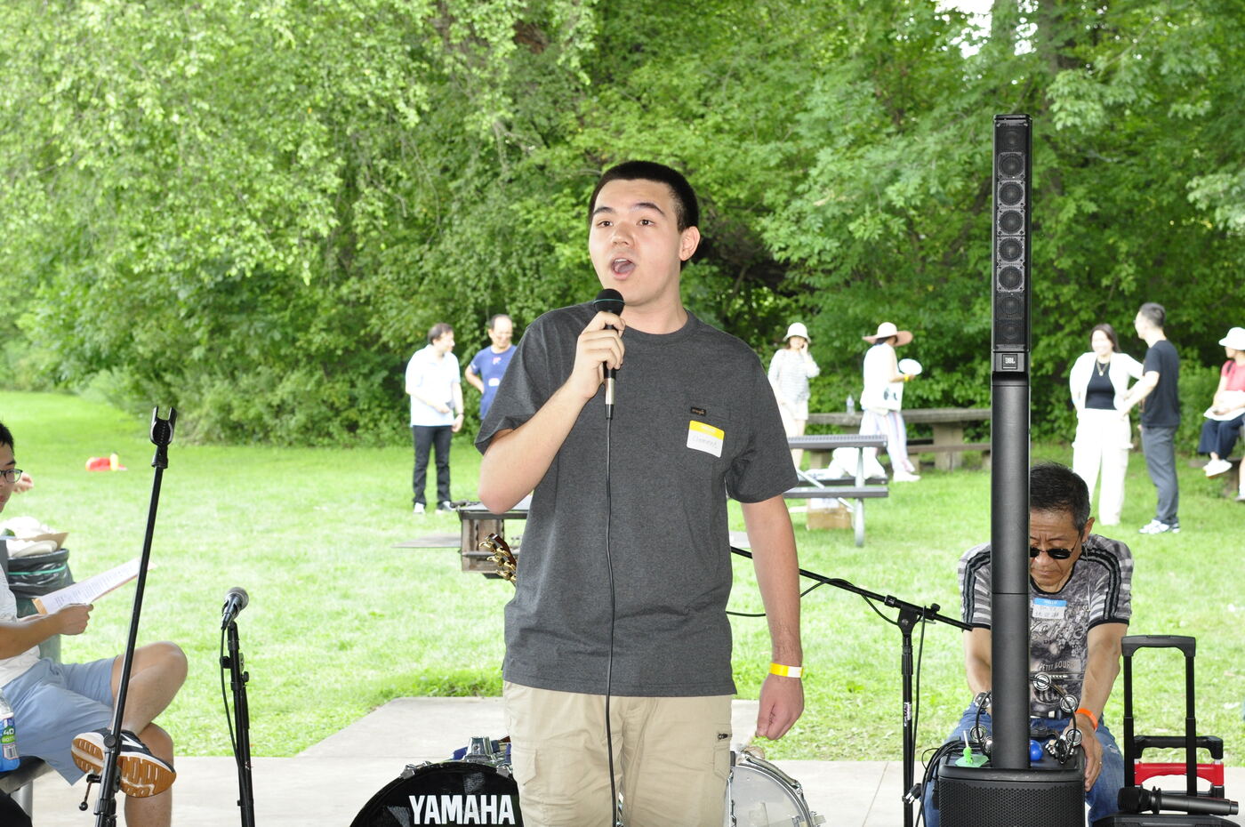 A young performer singing into the microphone.