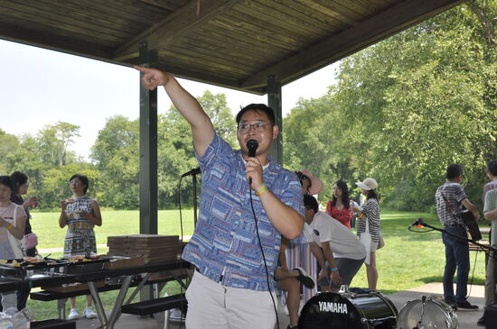 An organizer addressing the crowd with a microphone.